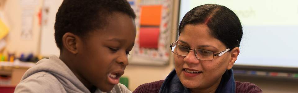 teacher supporting child